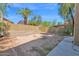 Spacious backyard featuring a tall brick wall, some trees and desert landscaping at 12842 S Wakial Loop, Phoenix, AZ 85044