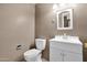 Bathroom featuring a toilet, sink with vanity and neutral paint at 12842 S Wakial Loop, Phoenix, AZ 85044