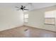 Bedroom with two windows, ceiling fan and tile flooring at 12842 S Wakial Loop, Phoenix, AZ 85044