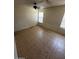 Bedroom with ceiling fan, two windows and tile flooring at 12842 S Wakial Loop, Phoenix, AZ 85044