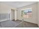 Bedroom with a twin bed, carpet flooring, and closet at 12842 S Wakial Loop, Phoenix, AZ 85044