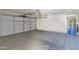 Spacious garage featuring an automatic door and a water heater at 12842 S Wakial Loop, Phoenix, AZ 85044