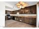 Kitchen with dark wood cabinets, light countertops, appliances, and a wine rack at 12842 S Wakial Loop, Phoenix, AZ 85044