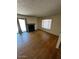Bright living room with hardwood floors, fireplace, and a window at 12842 S Wakial Loop, Phoenix, AZ 85044