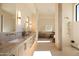 Elegant bathroom featuring dual sinks, marble countertops, a walk-in shower, vanity area, and modern lighting at 12887 N 135 St, Scottsdale, AZ 85259