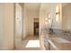 Luxurious bathroom with dual vanities, marble countertops, a walk-in shower, and modern fixtures at 12887 N 135 St, Scottsdale, AZ 85259