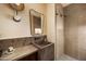 Stylish bathroom featuring a unique marble sink, decorative sconces, and glass-enclosed shower at 12887 N 135 St, Scottsdale, AZ 85259