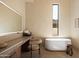 Bright bathroom featuring a soaking tub, vanity area and natural light at 12887 N 135 St, Scottsdale, AZ 85259