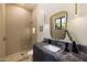 Modern bathroom features beautiful marble countertop, stylish mirror, and glass enclosed shower at 12887 N 135 St, Scottsdale, AZ 85259