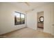Bright bedroom with wood floors, large window with views, and a bathroom ensuite at 12887 N 135 St, Scottsdale, AZ 85259