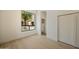 Bright bedroom featuring light wood floors, large window view, and closet space at 12887 N 135 St, Scottsdale, AZ 85259