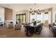 Elegant dining area with modern lighting, a large table, and stunning views of the desert landscape at 12887 N 135 St, Scottsdale, AZ 85259