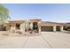 Stunning single-story home featuring a large driveway, desert landscaping, and a three-car garage at 12887 N 135 St, Scottsdale, AZ 85259
