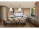 Modern kitchen with marble countertops, a spacious island, pendant lighting, and natural wood cabinets at 12887 N 135 St, Scottsdale, AZ 85259