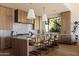 Modern kitchen featuring wood cabinetry, marble countertops, a large island, and pendant lighting fixtures at 12887 N 135 St, Scottsdale, AZ 85259