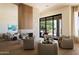 Inviting living room with fireplace, plush seating, and sliding doors showcasing picturesque landscape views at 12887 N 135 St, Scottsdale, AZ 85259