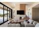Modern living room featuring a fireplace, comfortable seating, and sliding glass doors to the outdoors at 12887 N 135 St, Scottsdale, AZ 85259