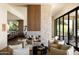 Open living room design with modern fireplace, comfortable seating, wood and stone accents, and abundant natural light at 12887 N 135 St, Scottsdale, AZ 85259