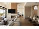 Open-concept living area with a modern fireplace, comfortable seating, and a view into the kitchen and dining area at 12887 N 135 St, Scottsdale, AZ 85259
