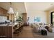 Bright, open-concept living room with a modern kitchen, cozy sectional sofa, and stylish decor at 12887 N 135 St, Scottsdale, AZ 85259