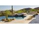 Backyard pool and spa featuring rock details and desert landscaping with scenic mountain views at 12887 N 135 St, Scottsdale, AZ 85259