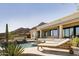 Resort-style pool and patio featuring stone decking, lounge chairs, lush landscaping, and mountain views at 12887 N 135 St, Scottsdale, AZ 85259