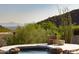 Relaxing spa features stone accents and scenic mountain views, providing a luxurious outdoor experience at 12887 N 135 St, Scottsdale, AZ 85259