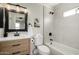 Stylish bathroom features a decorative mirror, vanity with drawers, and tiled tub/shower at 1352 W Naranja Ave, Mesa, AZ 85202
