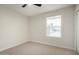 Carpeted bedroom with ceiling fan and a window providing natural light at 1352 W Naranja Ave, Mesa, AZ 85202