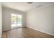 Versatile room with wood-look flooring and sliding glass doors that access the outdoor living space at 1352 W Naranja Ave, Mesa, AZ 85202