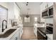 Bright kitchen showcasing white cabinets, stainless steel appliances, and an open layout at 1352 W Naranja Ave, Mesa, AZ 85202
