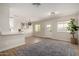 Open-concept living area featuring hardwood floors, neutral paint, and bright, natural light at 1352 W Naranja Ave, Mesa, AZ 85202