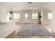 Bright and airy living room with an open floor plan and wood-look flooring at 1352 W Naranja Ave, Mesa, AZ 85202