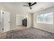 Spacious living room featuring neutral carpet and an adjoining room at 1352 W Naranja Ave, Mesa, AZ 85202