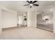 Open-concept living space featuring neutral carpet, wood flooring, and seamless flow to the kitchen at 1352 W Naranja Ave, Mesa, AZ 85202