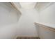Walk-in closet offers ample storage with wooden rods and shelving throughout at 1352 W Naranja Ave, Mesa, AZ 85202