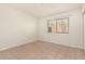 Bright bedroom with tile flooring, white walls, and large window for natural light at 1439 N 53Rd Ave, Phoenix, AZ 85043
