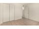 Bedroom featuring white walls, tile flooring, and a spacious closet for ample storage at 1439 N 53Rd Ave, Phoenix, AZ 85043