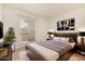 Nicely decorated bedroom with TV, window, and plants, with a calm and relaxing ambiance at 1439 N 53Rd Ave, Phoenix, AZ 85043