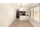 Empty dining area with tile flooring and adjacent kitchen at 1439 N 53Rd Ave, Phoenix, AZ 85043