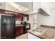 Efficient kitchen featuring black appliances, double basin sink, and tile backsplash at 1439 N 53Rd Ave, Phoenix, AZ 85043