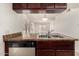 Kitchen featuring stainless steel dishwasher and double-basin sink, and an open view to the living room at 1439 N 53Rd Ave, Phoenix, AZ 85043