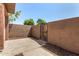 Enclosed patio area featuring a concrete slab and a stucco privacy wall with a gated entrance at 1439 N 53Rd Ave, Phoenix, AZ 85043