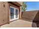 Enclosed patio featuring stucco wall, concrete slab, and a glass-paneled double door leading indoors at 1439 N 53Rd Ave, Phoenix, AZ 85043