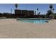 Community pool area with surrounding fence and greenery for a refreshing outdoor experience at 1439 N 53Rd Ave, Phoenix, AZ 85043