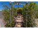 Gated backyard area featuring a water fountain, gravel landscaping, palm trees, and outdoor statues at 1628 E Aspen Ave, Buckeye, AZ 85326