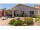 An outdoor patio includes brick pavers, an umbrella, and comfortable seating for relaxing and entertaining at 1628 E Aspen Ave, Buckeye, AZ 85326