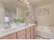 Bathroom with double sinks, tub, and stylish decor at 1628 E Aspen Ave, Buckeye, AZ 85326