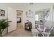 Bedroom featuring a cozy chair with a footstool, neutral color palette, and mirrored closet at 1628 E Aspen Ave, Buckeye, AZ 85326