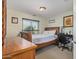 Bright bedroom with wooden accents, large window, and desk at 1628 E Aspen Ave, Buckeye, AZ 85326